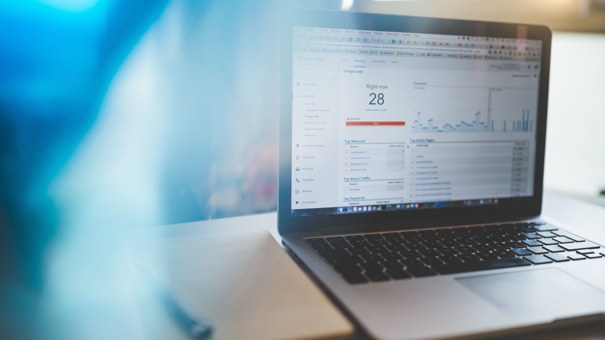 Laptop displaying Google Analytics in a modern workspace, highlighting digital analytics and technology